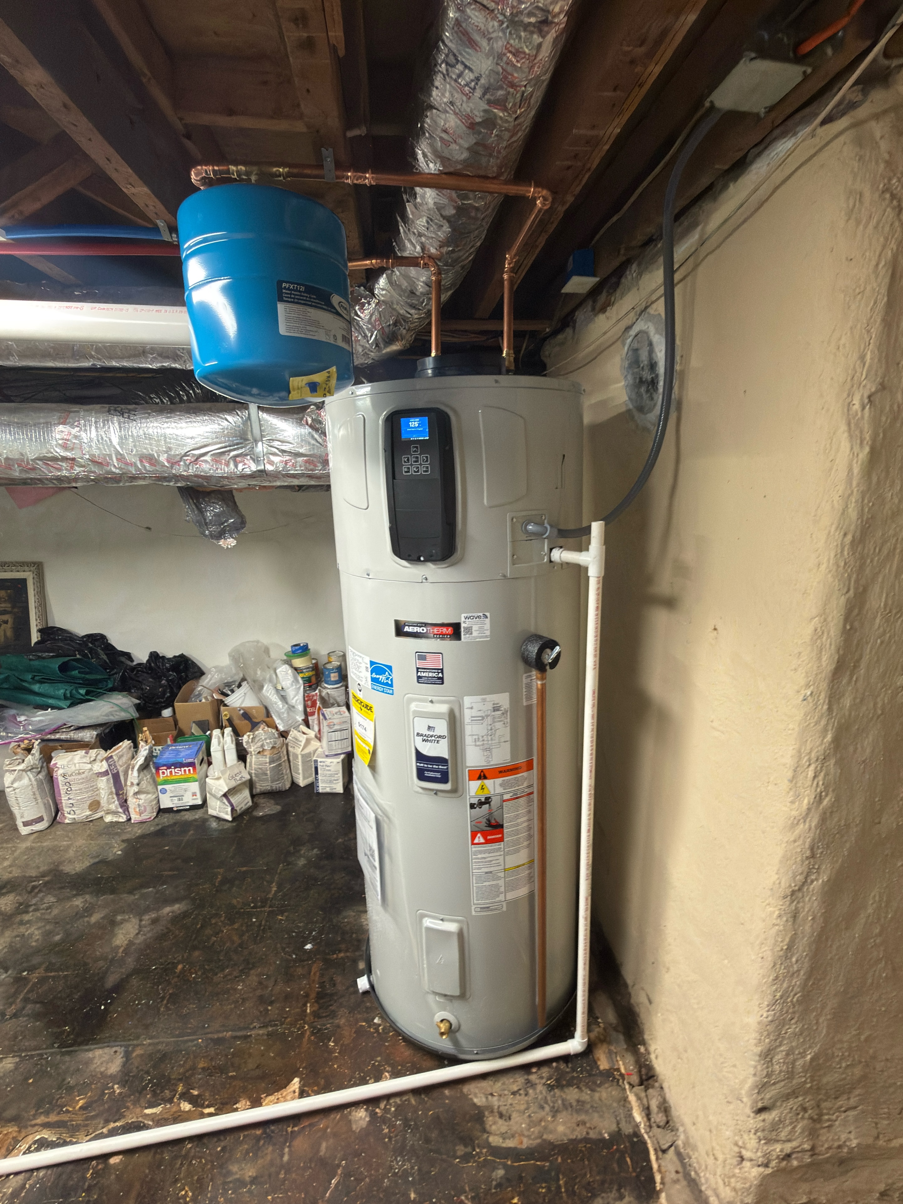 DMES LLC tank-style heat-pump water heater installed with associated piping and expansion tank